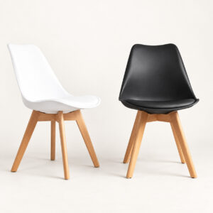 White and black padded Eames style dining chairs with natural wood legs on a light background